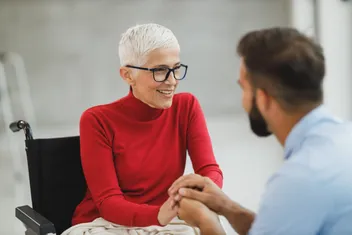 A licensed agent sitting with an older woman to talk through her options